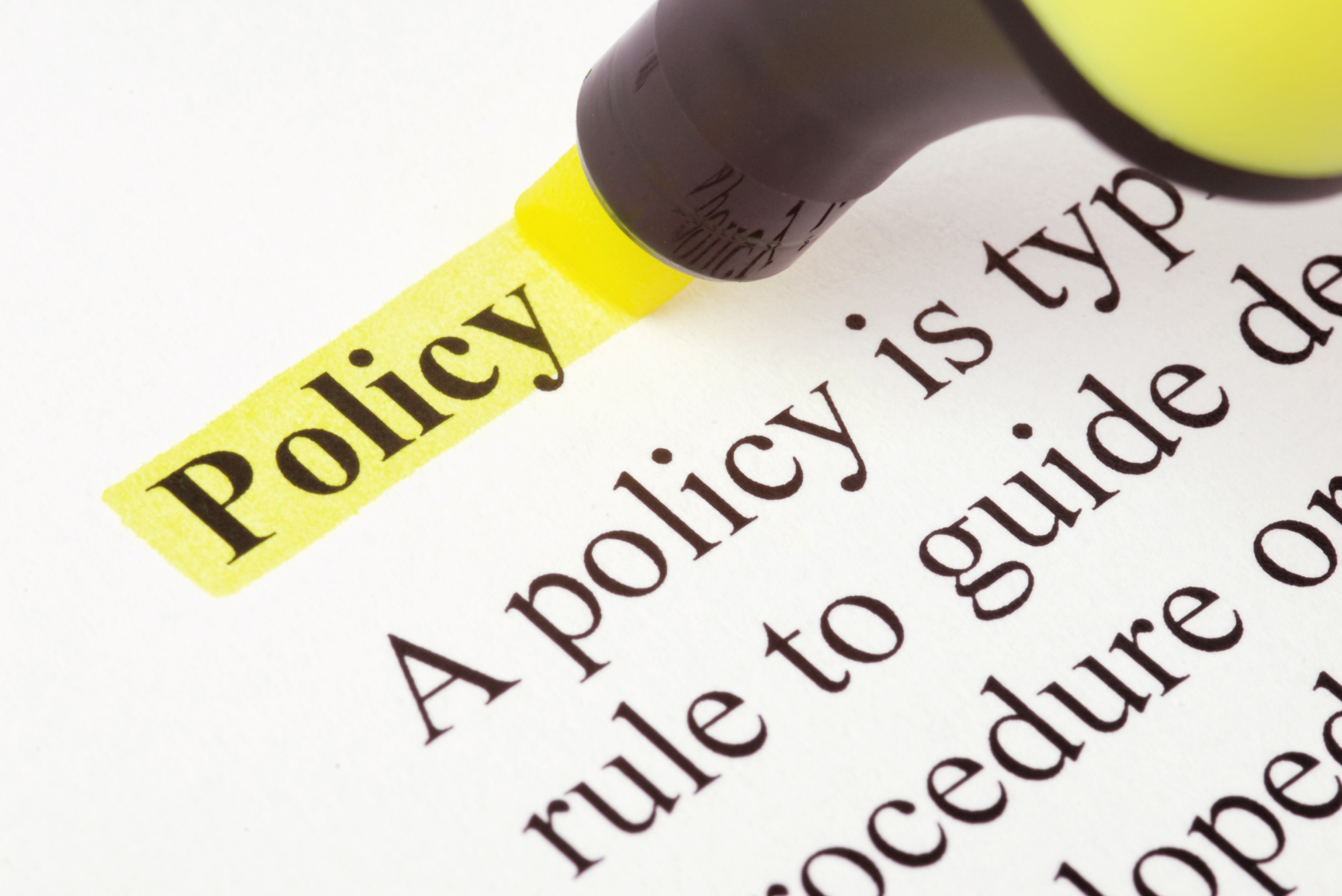 A yellow highlighter highlights the word “policy” at the top of a dictionary entry.