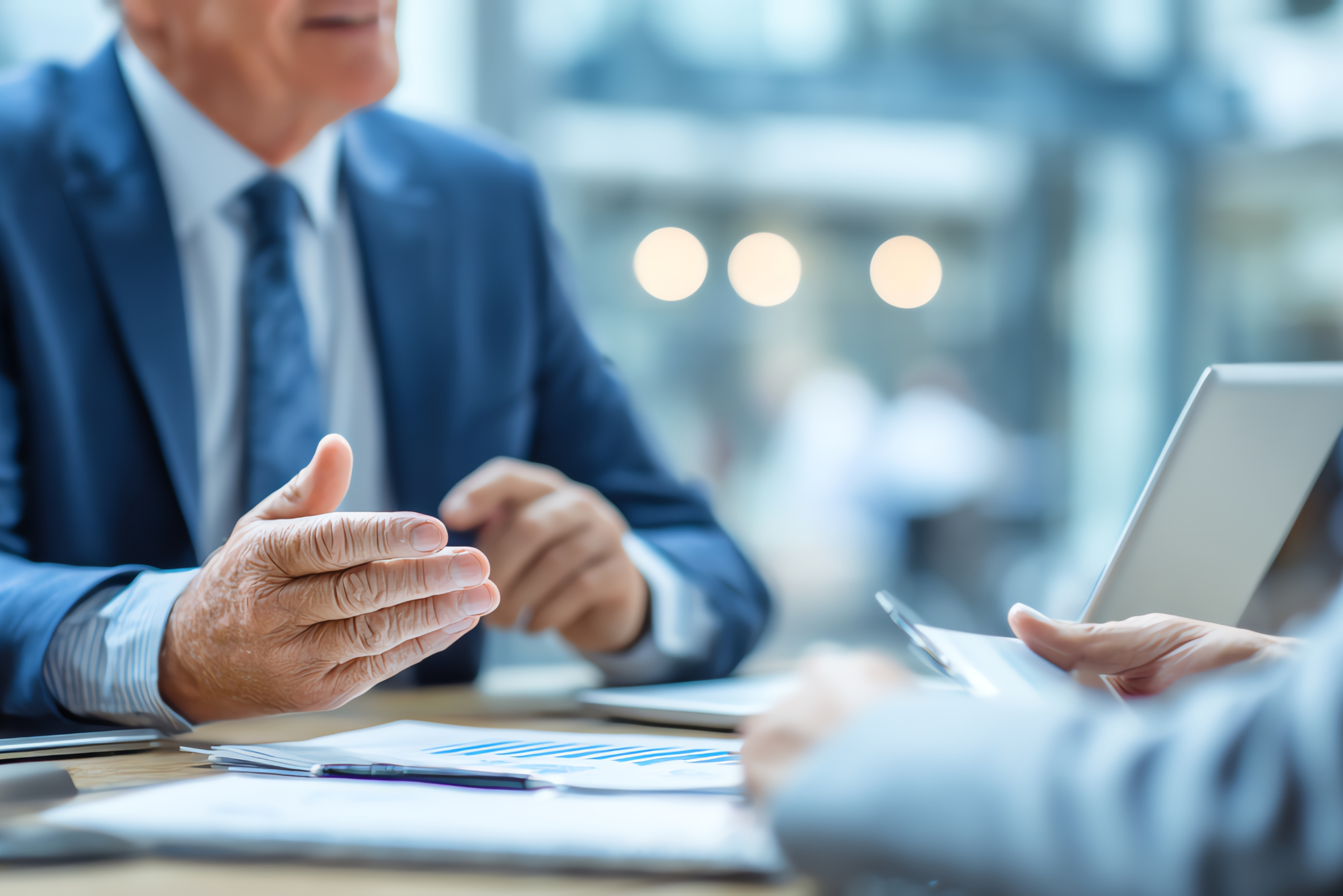 A man discussing documents with laptop.